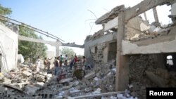 People gather at a prison struck by Arab coalition warplanes in al-Zaydiyah district of the Red Sea port city of Hodeidah, Yemen, Oct. 30, 2016.