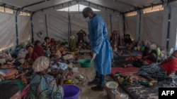 FILE - Doctor Robert Musole, medical director of the Kavumu hospital, visits patients recovering from mpox in the village of Kavumu, 30 kilometers north of Bukavu in eastern Democratic Republic of Congo on Aug. 24, 2024.