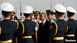 U.S. President Barack Obama passes an honor guard upon his arrival in Beijing, Nov. 10, 2014.
