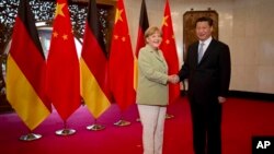 2014年，德國總理默克爾訪問中國與習近平會面。（資料圖片）