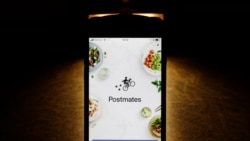 This Tuesday, Feb. 20, 2018, photo shows the Postmates app on an iPhone in Chicago. (AP Photo/Charles Rex Arbogast)