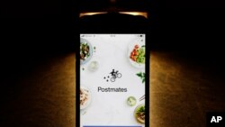 This Tuesday, Feb. 20, 2018, photo shows the Postmates app on an iPhone in Chicago. (AP Photo/Charles Rex Arbogast)