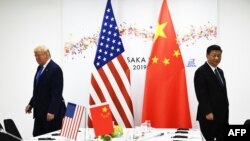 Le président chinois Xi Jinping (à droite) et le président américain Donald Trump assistent à leur réunion bilatérale en marge du sommet du G20 à Osaka le 29 juin 2019. (Photo: Brendan Smialowski / AFP)