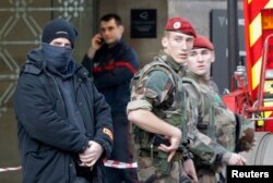 French police, soldiers and firefighters are seen in front of the street entrance of the Carrousel du Louvre in Paris, France, Feb. 3, 2017 .