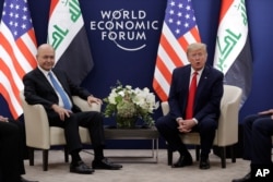 US President Donald Trump, right, attends a meeting with his Iraqi counterpart Barham Salih at the World Economic Forum in Davos, Switzerland, Jan. 22, 2020.