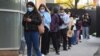 People queue for a COVID-19 test in Melbourne on May 27, 2021 after five million people in Melbourne were ordered into a snap week-long lockdown following another COVID-19 virus outbreak. 