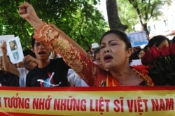 FILE - Bui Thi Minh Hang shouts during an anti-China protest in downtown Hanoi, July 24, 2011.