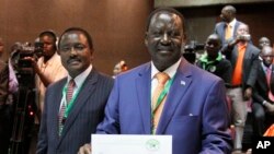 Orange Democratic Party, ODM, presidential candidate, Raila Odinga, right, displays his registration certificate, with running mate Vice President Kalonzo Musyoka, left, in Nairobi, Kenya, Jan. 30. 2013. 