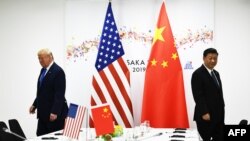 Le président américain Donald Trump et son homologue chinois Xi Jinping lors de leur réunion bilatérale en marge du sommet du G20 à Osaka, Japon, le 29 juin 2019. (Photo by Brendan Smialowski / AFP)