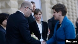 Czech Republic Prime Minister Bohuslav Sobotka, left, welcomes Polish Prime Minister Beata Szydlo at the summit of leaders of the Visegrad 4 group in Prague, Czech Republic, Dec. 3, 2015.