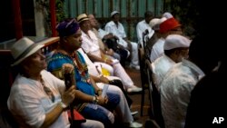 Santeria priests attend the reading of the annual Letter of the Year, written by Afro-Cuban Santeria priests, listing predictions for the new year in Havana, Cuba, Jan. 3, 2017. 