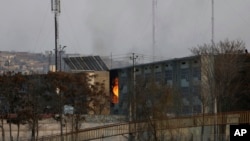 Flames rise from a government building after an explosion and attack by gunmen, in Kabul, Afghanistan, Monday, Dec. 24, 2018. 