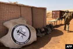 FILE - The France-led special operations logo for the new Barkhane Task Force Takuba, a multinational military mission in sub-Saharan Africa's troubled Sahel region, is seen Nov. 3, 2020.