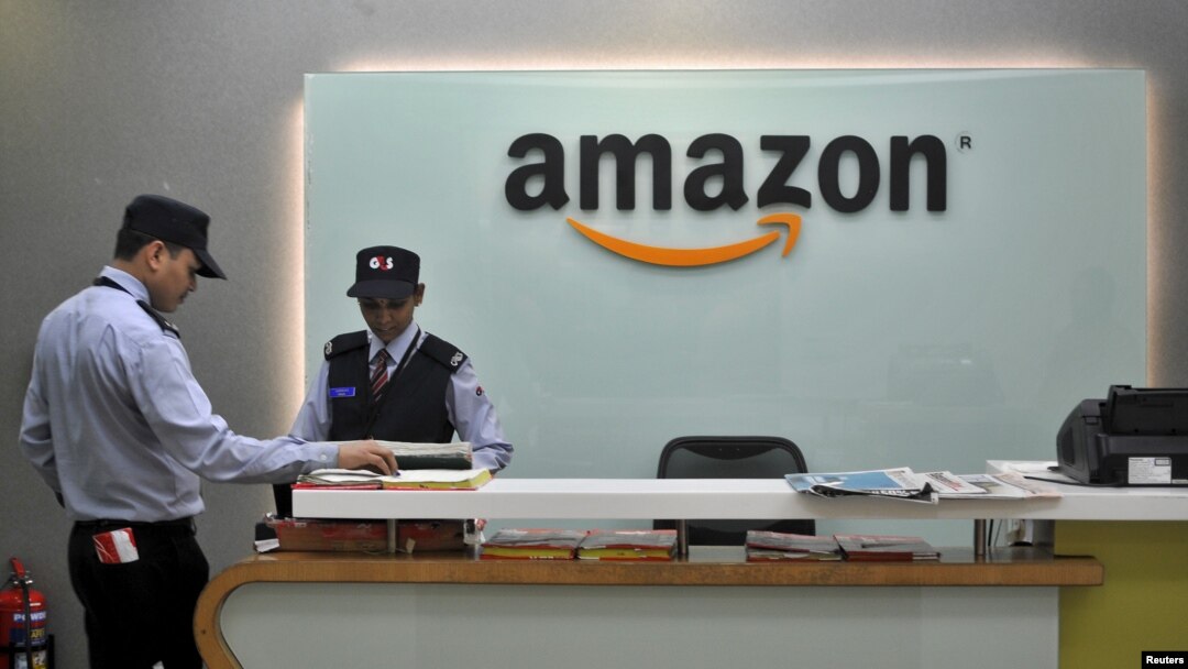 FILE - Security guards stand at the reception desk of the Amazon India office in Bengaluru, India, Aug. 14, 2015. 