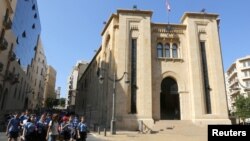 FILE - Students walk outside the parliament building in downtown Beirut, Lebanon.