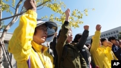 Keluarga korban kapal feri Sewol dan para pendukung mereka meneriakkan slogan, dan menuntut hukuman maksimal bagi nahkoda dan kru kapal tersebut, saat berlangsungnya sidang di pengadilan Gwangju, Korea Selatan (27/10).