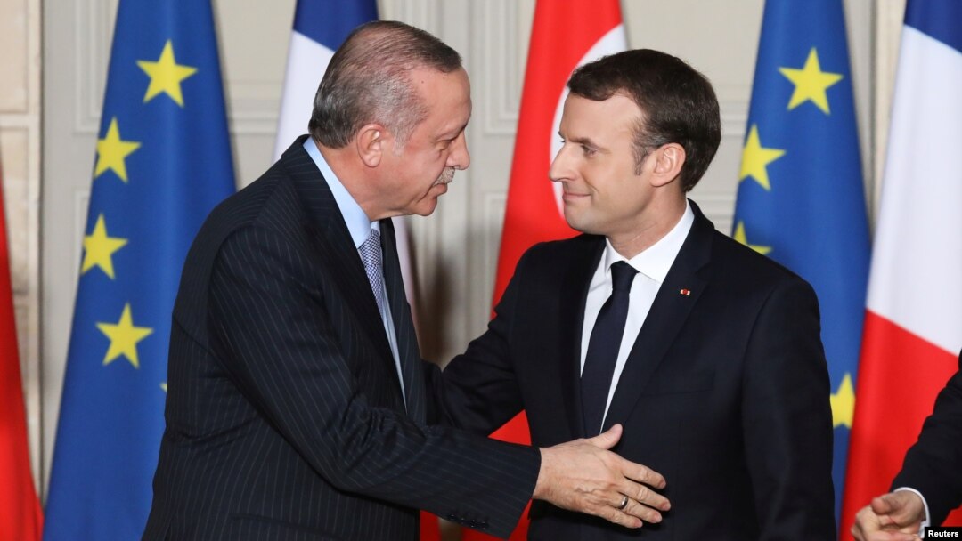 French President Emmanuel Macron greets Turkish President Recep Tayyip Erdogan during a joint news conference at the Elysee Palace in Paris, France, Jan. 5, 2018.