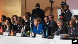German Chancellor Angela Merkel, center, attends a round table event at an EU Africa summit in Abidjan, Ivory Coast, Nov. 29, 2017.