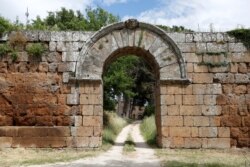 FILE - Porta di Giove, the main entrance to the ancient Roman city of Falerii Novi, which is mostly buried underground, is seen after researchers mapped the city using ground-penetrating radar technology, near Rome, Italy, June 9, 2020.