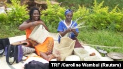 FILE - Catherine Kareaikwa and Regina Kaari weave baskets in Mathiga Village, Kenya, April 28, 2018. 