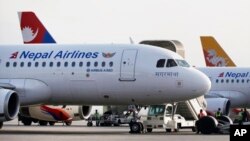 FILE PHOTO - Nepal Airlines Airbus 320 and other international airlines are seen parked inside Tribhuwan International airport in Kathmandu, Nepal, Monday, Nov. 9, 2015. 