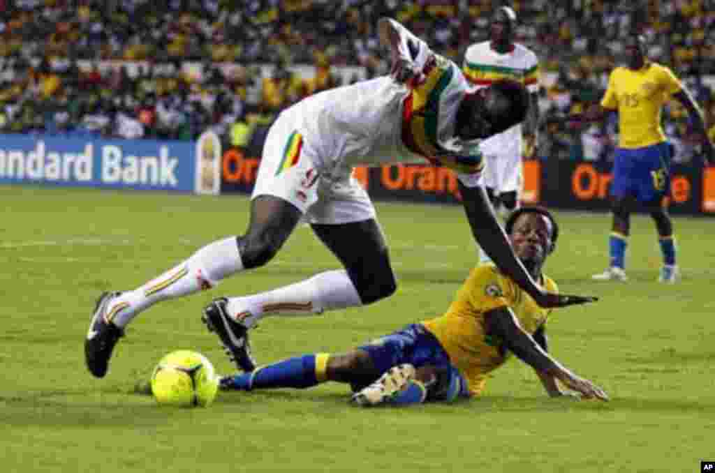 Mali's Cheick Diabate (L) is tackled by Gabon's Charly Moussono during their African Cup of Nations quarter-final soccer match at the Stade De L'Amitie Stadium in Gabon's capital Libreville, February 5, 2012.