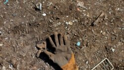 A glove left behind by a Palestinian worker is seen on the ground at a metal waste junkyard. The picture was taken January 25, 2021. REUTERS/Mohammed Salem