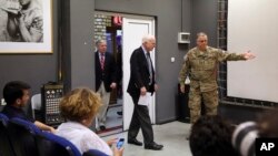 U.S. Sen. John McCain, center, arrives for a press conference at the Resolute Support headquarters in Kabul, Afghanistan, July 4, 2017. 