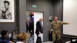 U.S. Senator John McCain, center, arrives for a press conference at the Resolute Support headquarters in Kabul, Afghanistan, July 4, 2017.