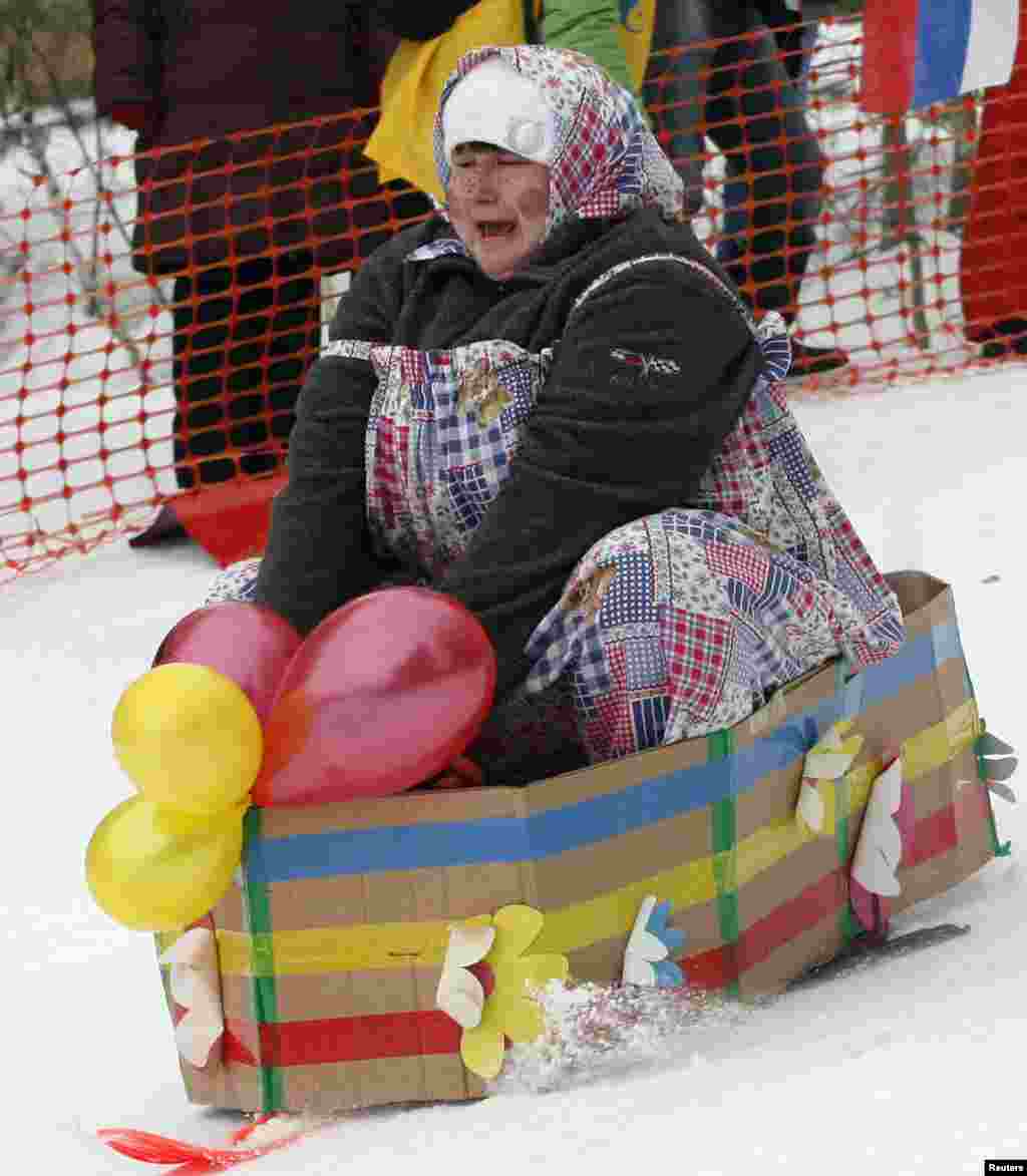 A participant competes during the 8th annual comic tobogganing competition, dedicated to the upcoming All Fools&#39; Day and the end of a winter sports season, at the Vetluzhanka ski stadium in the suburbs of Russia&#39;s Siberian city of Krasnoyarsk.