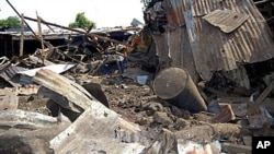 Shattered remnants are seen at the site of a bomb blast at a bar in the Nigerian city of Maiduguri, July 3, 2011