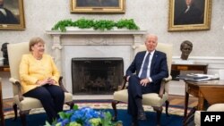 U.S. President Joe Biden and German Chancellor Angela Merkel hold a meeting in the Oval Office of the White House in Washington on July 15, 2021.