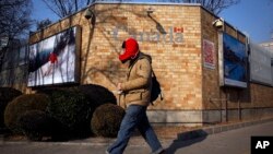 A man walks by the Canadian Embassy in Beijing, Dec. 14, 2018.