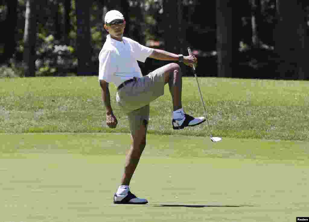 U.S. President Barack Obama reacts after missing a putt on the first green at the Farm Neck Golf Club at Oak Bluffs on Martha&#39;s Vineyard, Massachusetts, August 11, 2013.