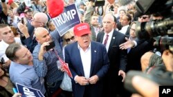 Republican presidential candidate Donald Trump, center, greets supporter after speaking at a campaign event aboard the USS Iowa battleship in Los Angeles, Sept. 15, 2015.