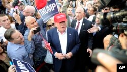 FILE - Republican presidential candidate Donald Trump, center, greets supporters in Los Angeles, Sept. 15, 2015.