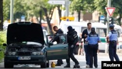 FILE - Police specialists looks into a car in Berlin, Germany, May 29, 2017. 