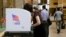 People cast their votes at a polling station inside the Enoch Pratt Free Library's central library branch in Baltimore, April 26, 2016.