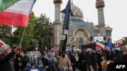 FILE - Iranians celebrate following Iran's missiles and drones attack on Israel, on April 15 2024, at Palestine square in central Tehran.