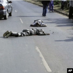 Photo published by the Daily Nation newspaper shows two Kenyan men lying dead on January 19, 2011 moments after they were shot by alleged undercover police officers on a major thoroughfare in Nairobi, 20 Jan 2011