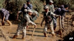 Rescue teams search for people missing after flash floods in the Madaba area, south of Amman, Jordan, Nov. 10, 2018.