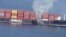 In this photo released by the Canadian Coast Guard and received by AFP on October 24, 2021, smoke is seen rising from the side of the container ship Zim Kingston off Canada's Pacific coast.