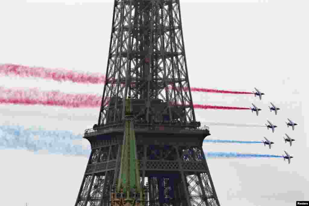 Alphajet planes from the Patrouille de France (France's Patrol) fly past the Eiffel Tower in Paris July 13, 2012 on the eve of the traditional Bastille Day military parade. 