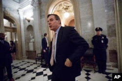 FILE - Sen. Mark Warner leaves the Senate chamber on Capitol Hill in Washington, Feb. 3, 2017. Warner said the SSCI "expect [Kushner] to be able to provide answers to key questions that have arisen in our inquiry."