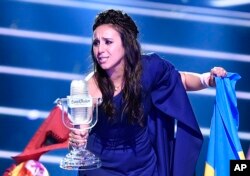 Ukraine's Jamala celebrates with the trophy after winning the Eurovision song contest final with "1944" in Stockholm, Sweden, May 15, 2016.