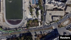 A general view taken with a drone shows buses parked outside the municipal stadium in the government-controlled area of Aleppo, as they wait to evacuate people wishing to leave besieged eastern Aleppo, Syria, Oct. 20, 2016.