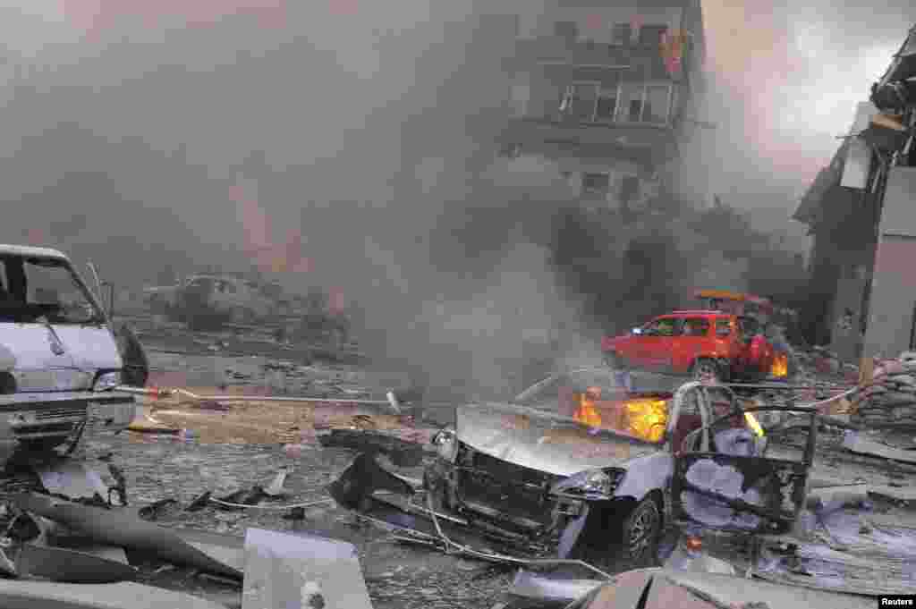 Vehicles burn after an explosion at central Damascus February 21, 2013, in this handout photograph released by Syria's national news agency SANA. The big explosion shook the central Damascus district of Mazraa on Thursday, residents said, and Syrian state