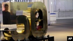 Visitors pose for photos around a Super Bowl sign at Levi's Stadium Saturday, Jan. 30, 2016, in Santa Clara, Calif.