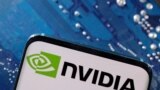 FILE - A smartphone with a displayed NVIDIA logo is placed on a computer motherboard in this illustration taken March 6, 2023. 