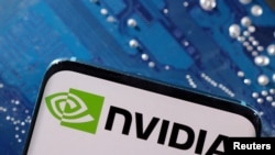 FILE - A smartphone with a displayed NVIDIA logo is placed on a computer motherboard in this illustration taken March 6, 2023. 